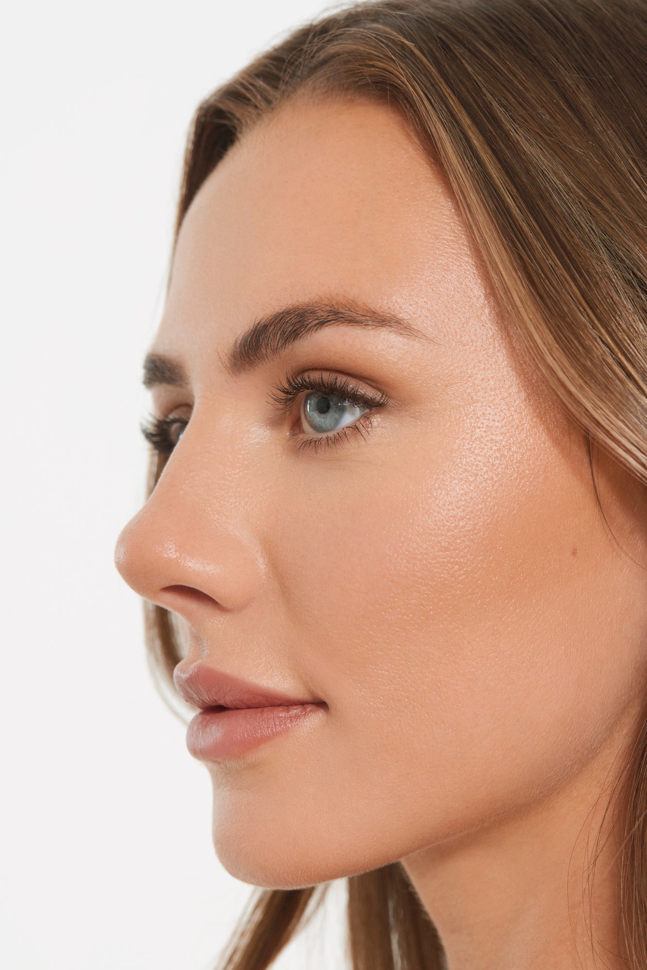 Close-up of a woman's face with permanent makeup, including lip blush and microshading, resulting in a natural and flawless look.